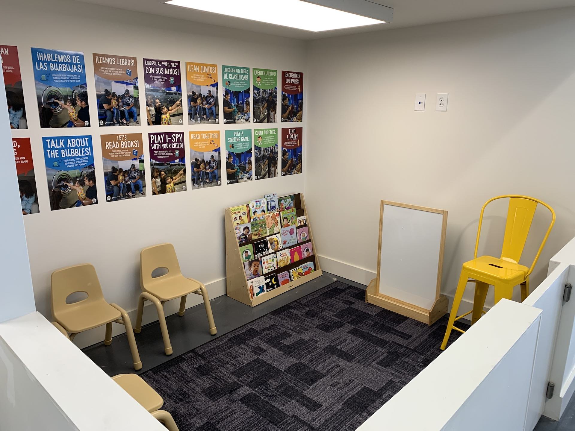 The kids area at Oz Laundry with small chairs and books